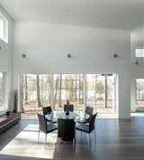 Dining Room, Recessed Lighting, Dark Hardwood Floor, Table, Wall Lighting, and Chair Extensive glazing facing the lake brings the outdoors and natural lighting into the house.  Photo 8 of 11 in The Wolf-Huang House by Kim Weiss