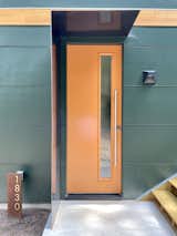 Front door with metal protection from rain. The emerald-green exterior suggests the "jewel box" interior.  Photo 5 of 16 in A Jewel Box for a Special Ops Soldier by Kim Weiss