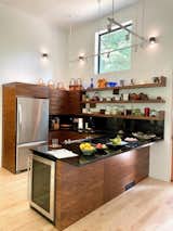 Custom-designed cabinetry and shelving by Arielle Schechter, AIA, form the little kitchen.  A window placed above the kitchen invites natural illumination.