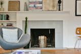 Classic 50's fireplace painted grey bricks and white mantel.