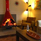 Mid Century cabin interiors are often warm and comfortable with an emphasis on family gathering paces like dining tables or areas to gather around the fire.