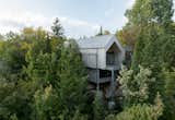 Exterior, Wood Siding Material, Cabin Building Type, Metal Roof Material, and Gable RoofLine A view of the chalet nestled in the trees on the steeply sloped, forested site  Photo 1 of 59 in Chalet Papillon by RobitailleCurtis
