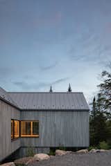 Exterior, Gable RoofLine, Metal Roof Material, Cabin Building Type, and Wood Siding Material A view of the primary suite from the entry drive; looking west  Photo 6 of 59 in Chalet Papillon by RobitailleCurtis