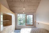 Bedroom, Bed, Dresser, Wardrobe, Pendant Lighting, Concrete Floor, and Ceiling Lighting A view if the primary bedroom; looking southwest  Photo 17 of 59 in Chalet Papillon by RobitailleCurtis