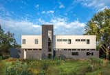 Exterior, House Building Type, Stucco Siding Material, and Flat RoofLine Street fenestration accentuated by tower to terminate street and prairie grass lawn.  Photo 2 of 12 in Burnett Solar House by Steven Ginn