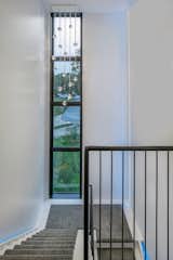 Staircase, Metal Railing, and Wood Tread Steps at the tower centered on the street  Photo 4 of 12 in Burnett Solar House by Steven Ginn