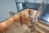Cable rail stair landing open to kitchen below