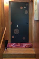 We are currently working on installations of our doors in home interiors, here is one of the first during a fitting for installation.  The door adds a stunning and needed contrast to a hall and stair area done regal solid red oak panels. 