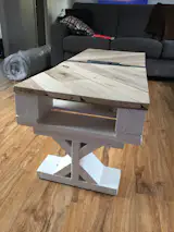 This coffee table is made from 100% reclaimed wood from pallets. A small recession in the center for storage and a shelf below for magazines. 