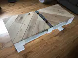 This coffee table is made from 100% reclaimed wood from pallets. A small recession in the center for storage and a shelf below for magazines. 