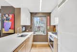 Windowed Kitchen with Custom Bamboo Cabinetry and Recycled Glass Countertops