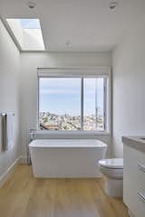 Bath Room, Light Hardwood Floor, and Freestanding Tub  Photo 18 of 31 in Bathrooms We'd Bathe In by Model Remodel from Randall Street