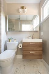 Small bathroom featuring walnut floating vanity paired with calacatta hex marble mosaic