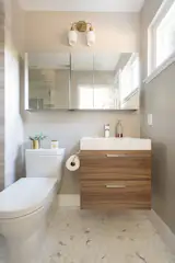 Small bathroom featuring walnut floating vanity paired with calacatta hex marble mosaic