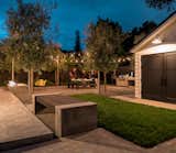 There is room to set up seating for an outdoor movie projected on side wall of the garage