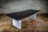 This table is a blackened ash dining table on concrete legs.  Ash is an amazing wood to stain because its grain is so prominent.
