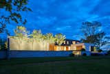 Exterior, Wood Siding Material, Concrete Siding Material, Stucco Siding Material, House Building Type, Flat RoofLine, and Green Roof Material Rear Approach - Dusk  Photo 16 of 18 in Calloway Ridge House by Brandon Pace