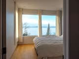 Bedroom, Ceiling Lighting, Bed, and Light Hardwood Floor The view from the master bedroom  Photo 10 of 26 in Lighthouse by Julien Miville