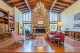 Living Room with soaring ceilings, heart pine floors, and built in cabinetry.  Wrought iron chandelier adds a rustic elegance.