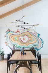 The Dining Room is framed with a custom colorful mural that is inspired by the rings in a tree trunk. 
