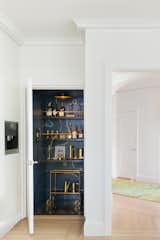 Elevator with hand painted mural and brass bar cart.