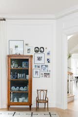 Heirloom curio cabinet and family photo gallery wall.