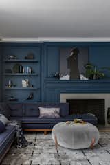 Living room with tone-on-tone navy walls and sofa.