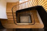 Stairwell; curved blackened steel with bronze top cap.