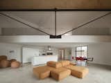 Living Room, Sectional, Concrete Floor, Ceiling Lighting, and Ottomans Feline / Grand Room (40' suspended Steel Truss)  Photo 11 of 17 in Feline by Atelier RZLBD