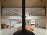 Living Room, Ceiling Lighting, Concrete Floor, and Hanging Fireplace Feline / Grand Room (40' suspended Steel Truss)  Photo 12 of 17 in Feline by Atelier RZLBD