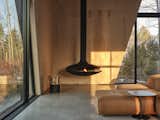 Living Room, Hanging Fireplace, Concrete Floor, and Ceiling Lighting Feline / Suspended Fireplace  Photo 15 of 17 in Feline by Atelier RZLBD