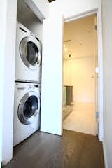 A stacked washer and ventless dryer fit in a closet with a bifold sliding door.