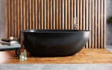 Aquatica's Spoon 2 Graphite Black egg-shaped freestanding bathtub is equally unique and understated. Crafted from AquateX™ Graphite Black solid surface material, Spoon 2 has a matte finish that is velvety smooth to the touch yet is exceptionally durable with superior heat retention qualities.   Photo 1 of 12 in AquateX™ solid surface bathtubs by Aquatica Bath
