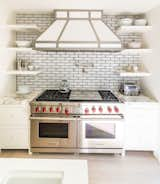 Calcutta marble adorns this beautiful stove top with dual oven and built in shelves