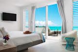 Upstairs bedrooms offer direct access to a sprawling oceanfront terrace.