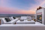An outdoor gathering, dining and entertaining space with fireplace. 
