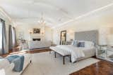 The 1700-square-foot master bedroom showcases inlaid walnut floors, a large fireplace, and French doors to a private terrace.