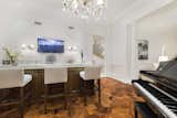 A refined salon  holds a stunning marble slab bar and French doors to the loggia.