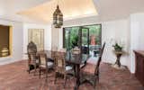 A generous formal dining room boasts doors to the pool and gardens for a gracious indoor-outdoor flow.