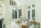 Towering ceilings and expansive windows take full advantage of the home's lush surroundings.