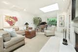A generous living room is enhanced by a large skylight, fireplace, and white oak floors.