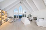 Vaulted ceilings and beautiful cathedral windows heighten the space and scale of the living room