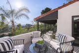 A tiled patio off an upstairs bedroom is a peaceful retreat, overlooking views of Hollywood and Century City all the way to the ocean.