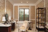 A sumptuous master bath showcases marble top vanities, upholstered walls, dual showroom closets, hand-cut marble flooring and a deep, free-standing soaking tub. 

