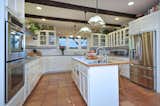 The generous chef's kitchen features a large eat-in center island and striking views of the rolling hills.