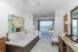 The ensuite master bath opens to the pool and ocean view. 