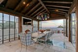 A second dining area is nestled poolside with ocean views, bi-folding glass doors and fireplace. 