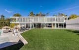 Outdoor, Grass, Back Yard, Large Pools, Tubs, Shower, Concrete Patio, Porch, Deck, and Trees Laden with a series of custom-designed, Swisspearl cement board panels and geometric louvres, glass-enclosed living spaces are shielded from the sun while taking full advantage of natural light and available views.
  Photo 1 of 11 in An Architectural Gem on the Bird Streets of Los Angeles by Luxury Homes & Lifestyle