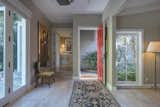 A gracious entryway with white oak hardwood floors leads to the bright and open living room.