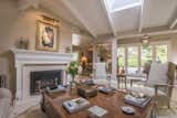 The living room features white oak hardwood floors, pitched beamed ceilings, a fireplace and skylights that bathe the space in natural light.